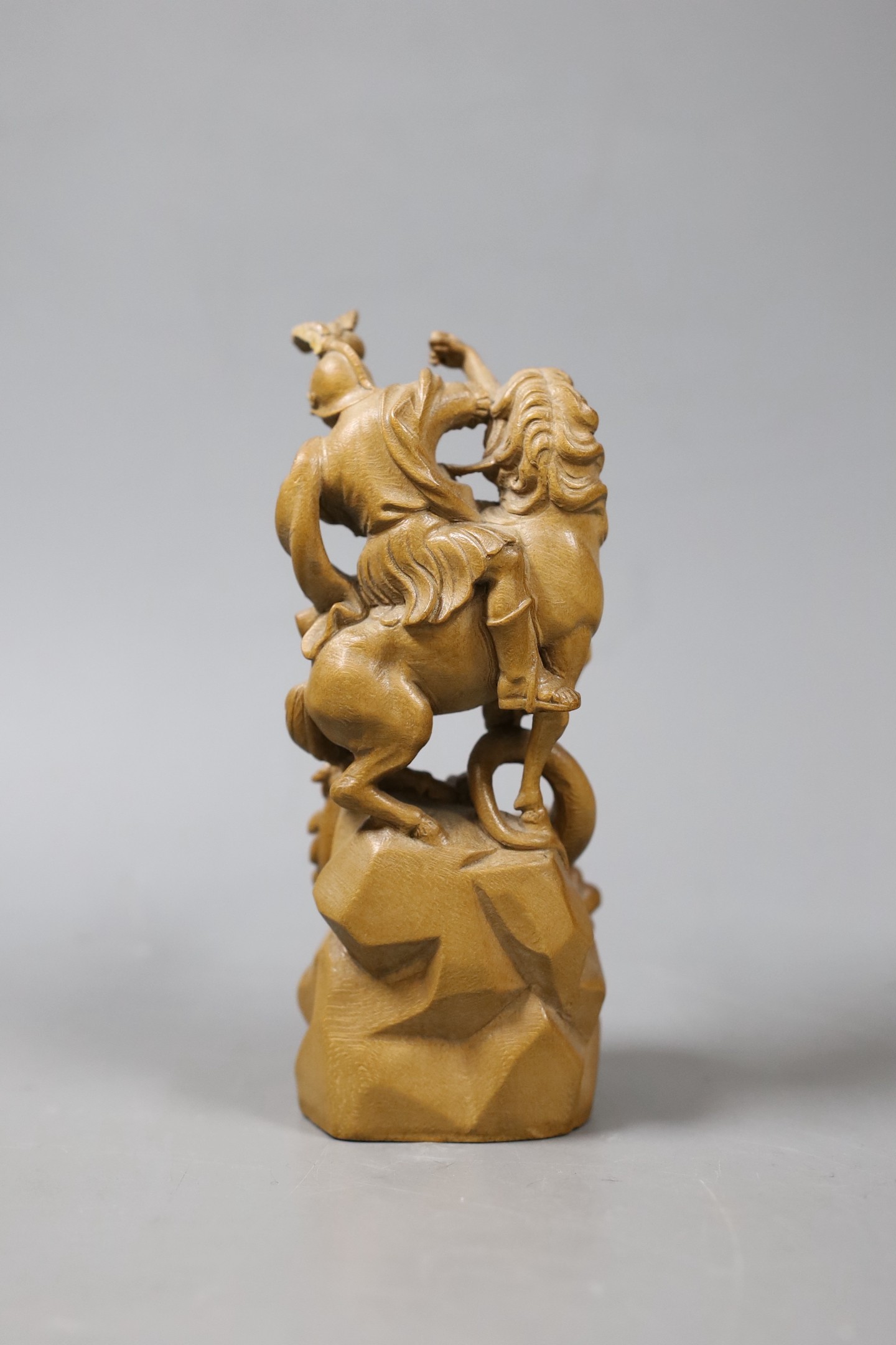 A Continental limewood group of St George and the dragon. 14cm high